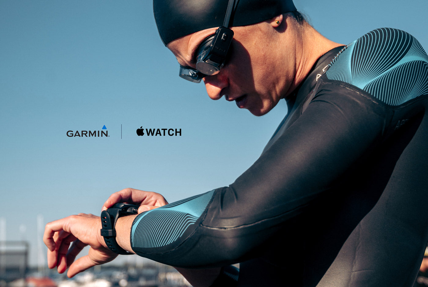 Swimmer checking their watch showing swum, pace, stroke rate data and more in open water swimming.